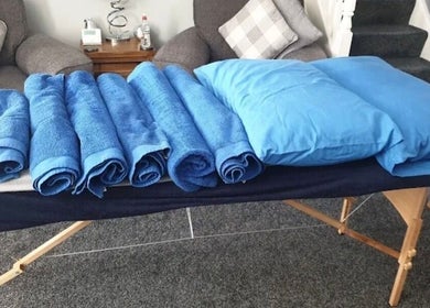 Massage table with blue towels at Trudy Wilson Mobile Massage and Holistic Therapies, Larbert, Scotland, GB.