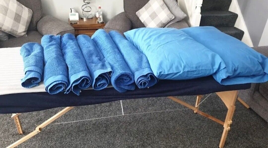 Massage table with blue towels at Trudy Wilson Mobile Massage and Holistic Therapies, Larbert, Scotland, GB.