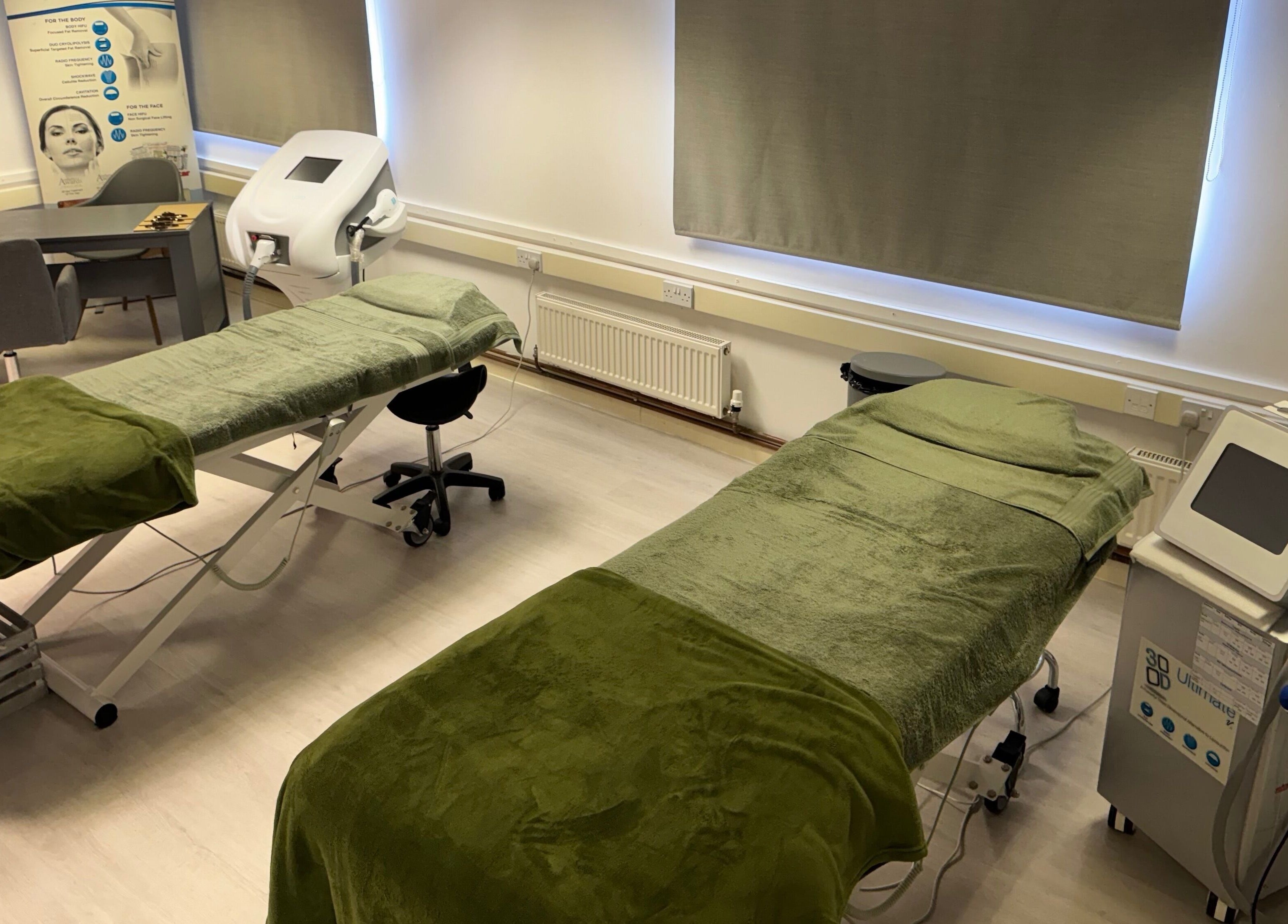 Treatment room at Harmony Clinic, Woodbridge, England, GB, featuring luxury massage tables and advanced equipment.