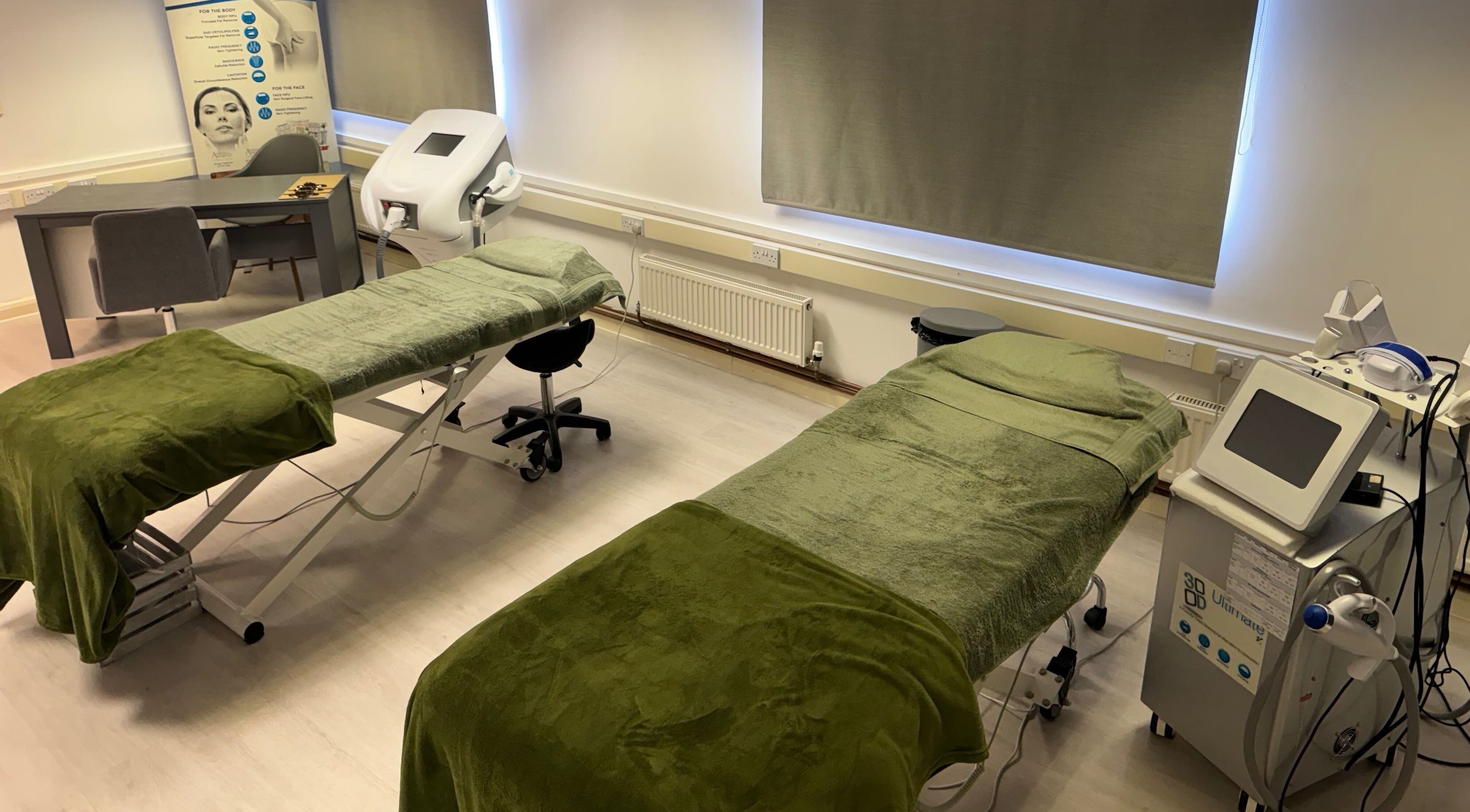 Treatment room at Harmony Clinic, Woodbridge, England, GB, featuring luxury massage tables and advanced equipment.