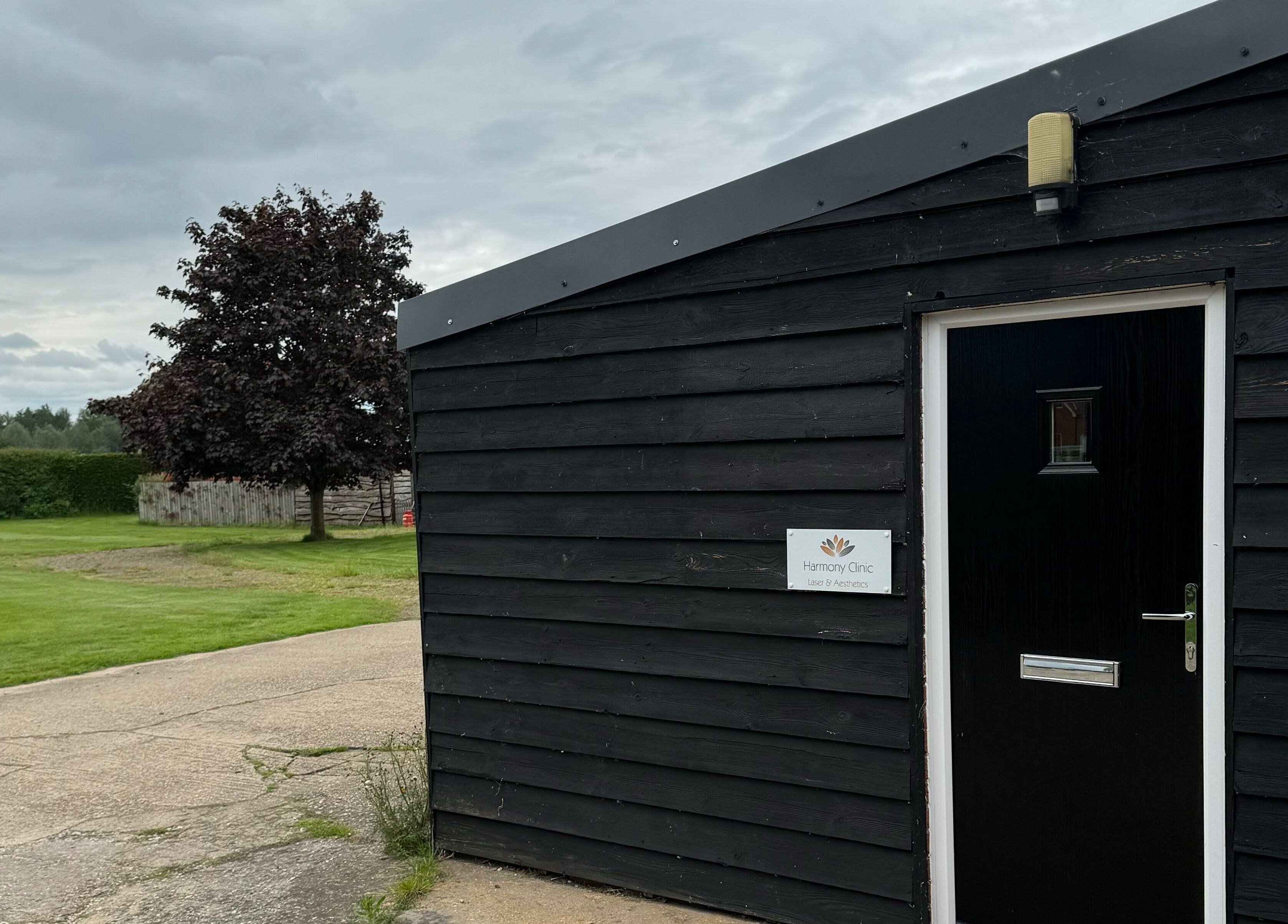 Entrance to Harmony Clinic, Woodbridge, England with green lawns and a serene environment.