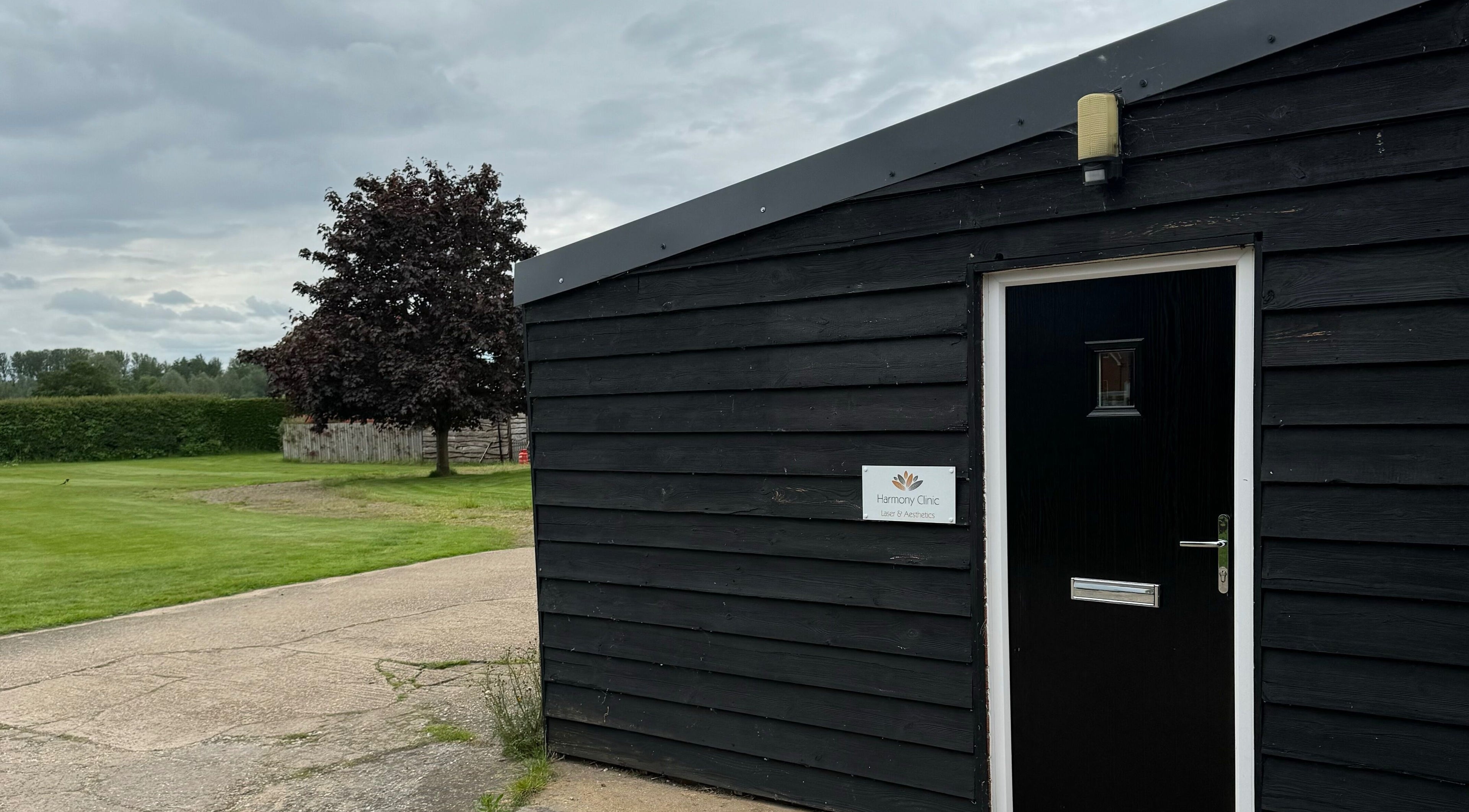 Entrance to Harmony Clinic, Woodbridge, England with green lawns and a serene environment.