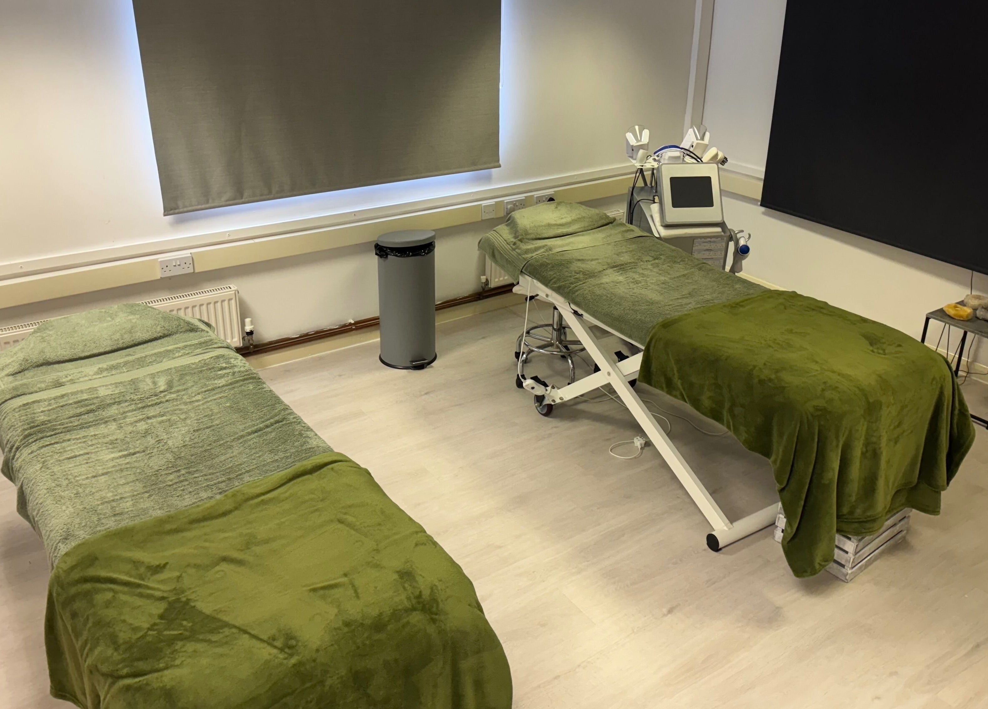 Therapy room at Harmony Clinic in Woodbridge, England, with two treatment beds and calming decor.