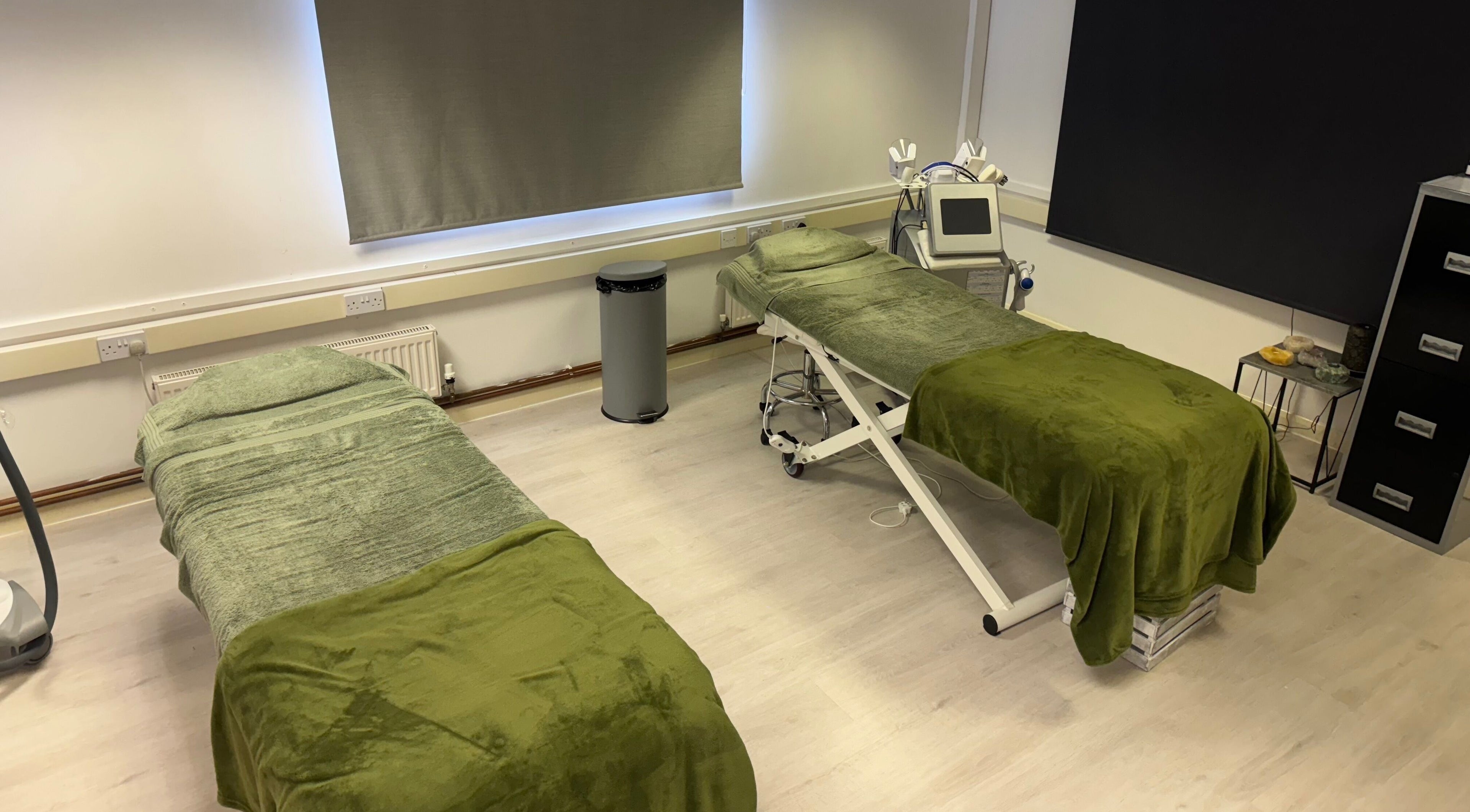 Therapy room at Harmony Clinic in Woodbridge, England, with two treatment beds and calming decor.
