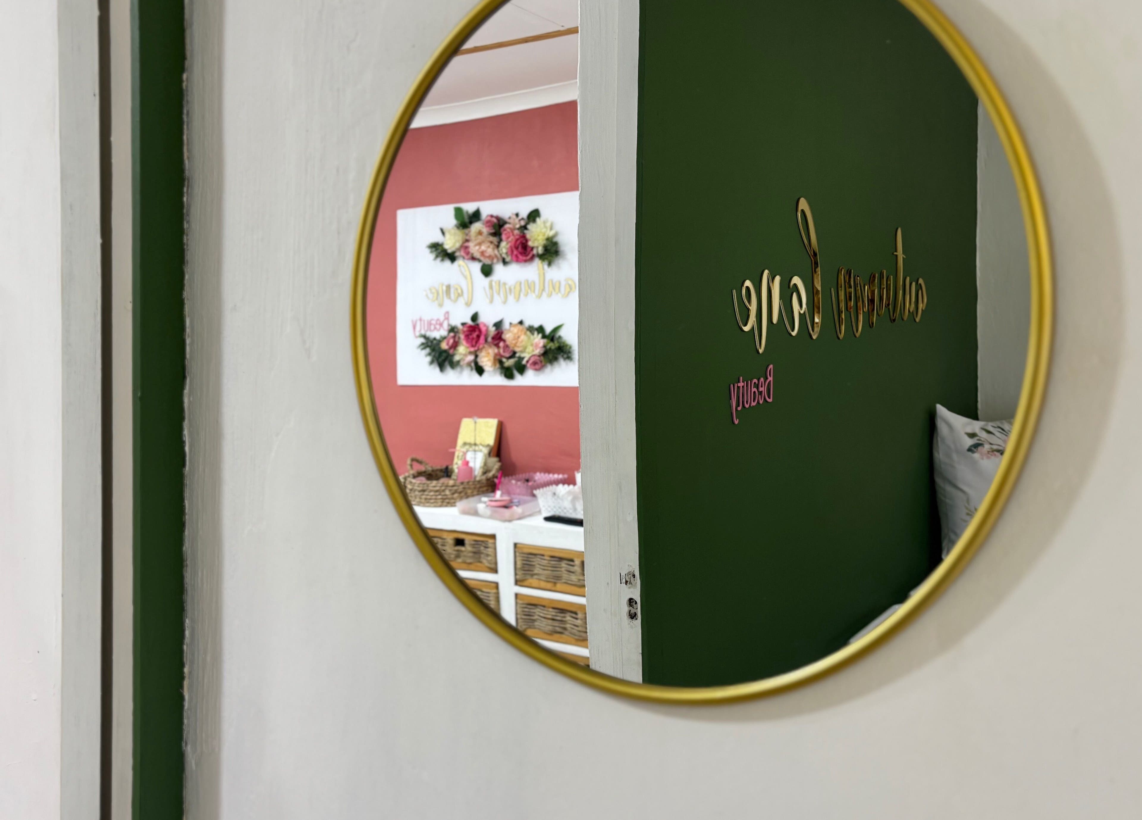 Reflection of Autumn Lane Beauty's elegant entrance in a round mirror at Margate, Kwazulu-natal, ZA.