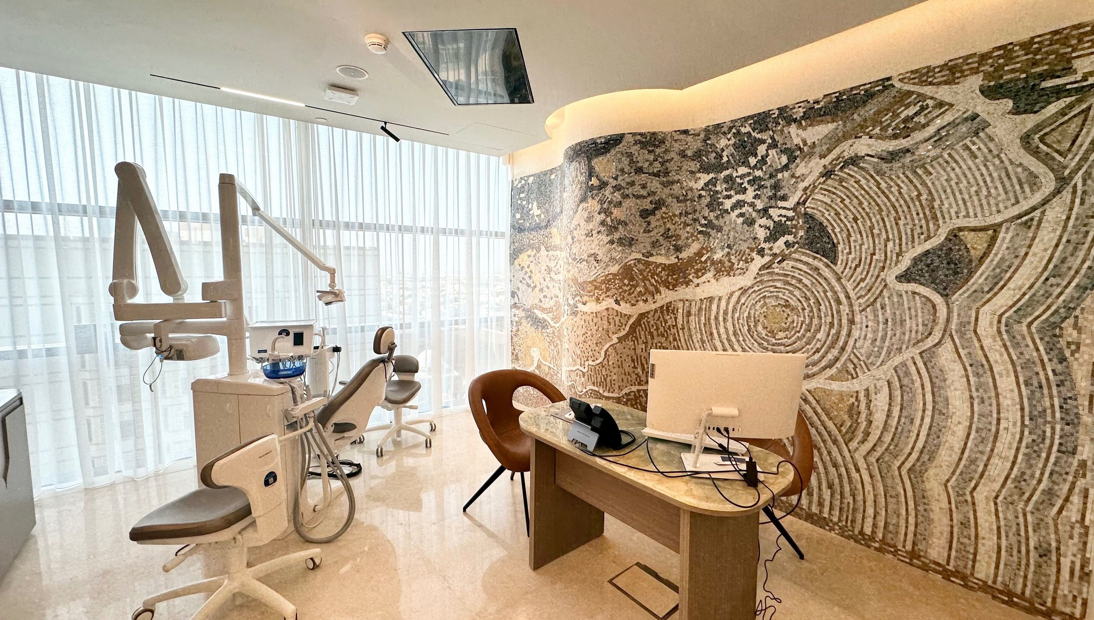 Modern dental office at Apex Clinic in Jeddah, Makkah Province, SA with mosaic wall and dental chair.
