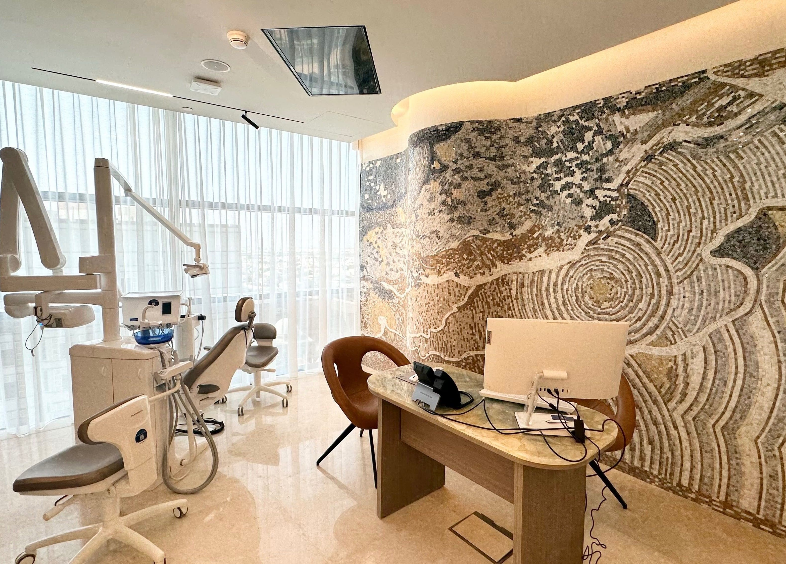 Modern dental office at Apex Clinic in Jeddah, Makkah Province, SA with mosaic wall and dental chair.