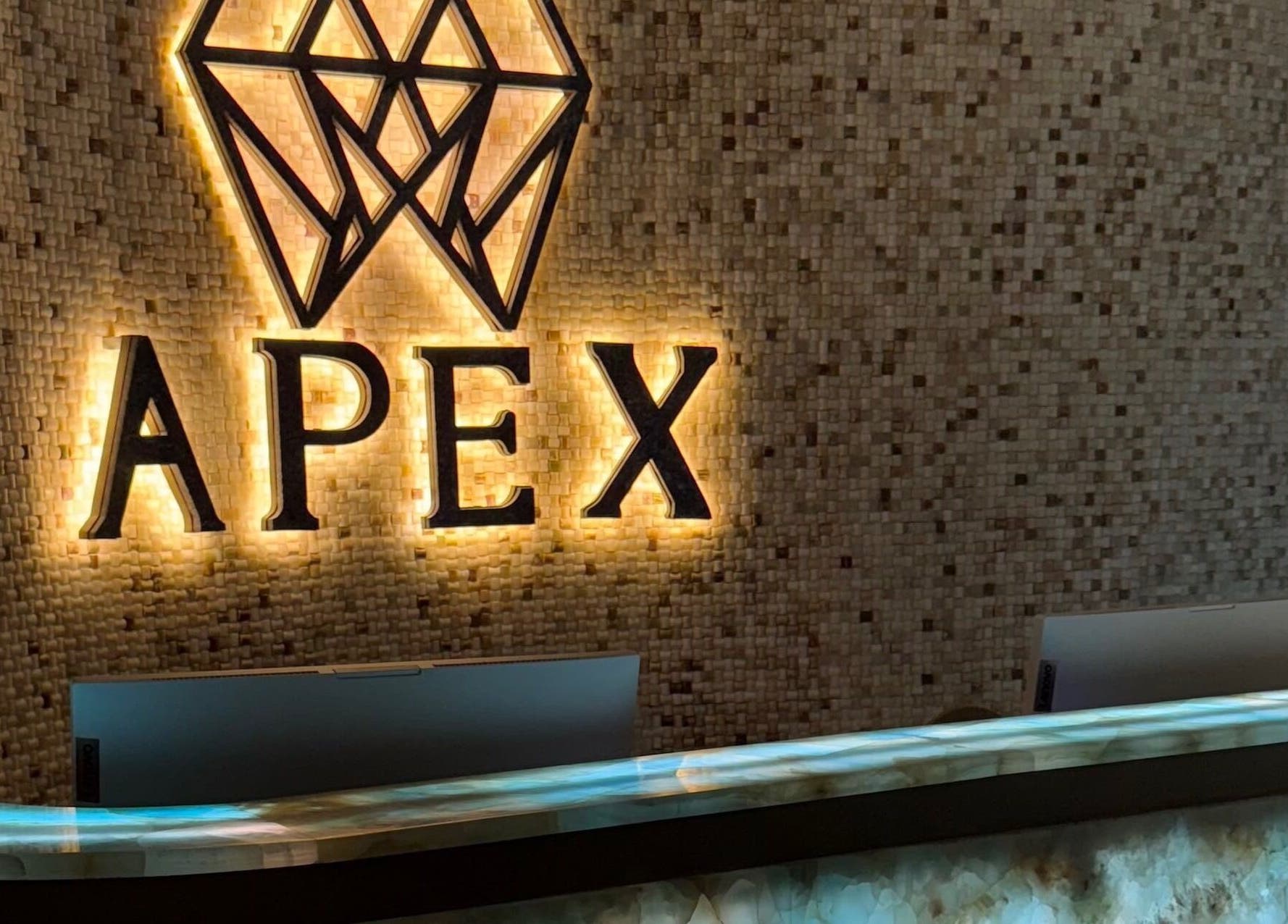 Elegant Apex Clinic reception in Jeddah, Makkah Province, SA featuring illuminated logo and modern design.