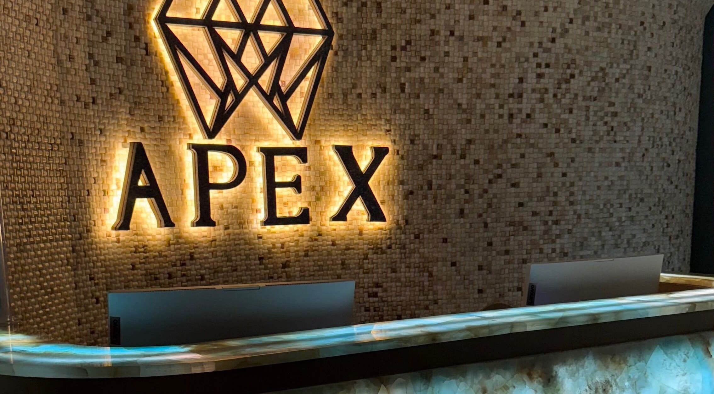 Elegant Apex Clinic reception in Jeddah, Makkah Province, SA featuring illuminated logo and modern design.