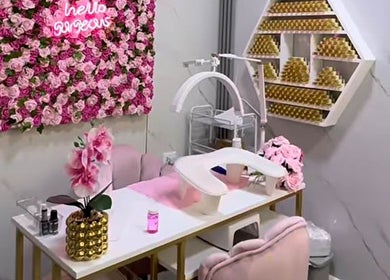 Nail station at Embelli Shed By Aya, Aley, adorned with pink roses and chic decor.