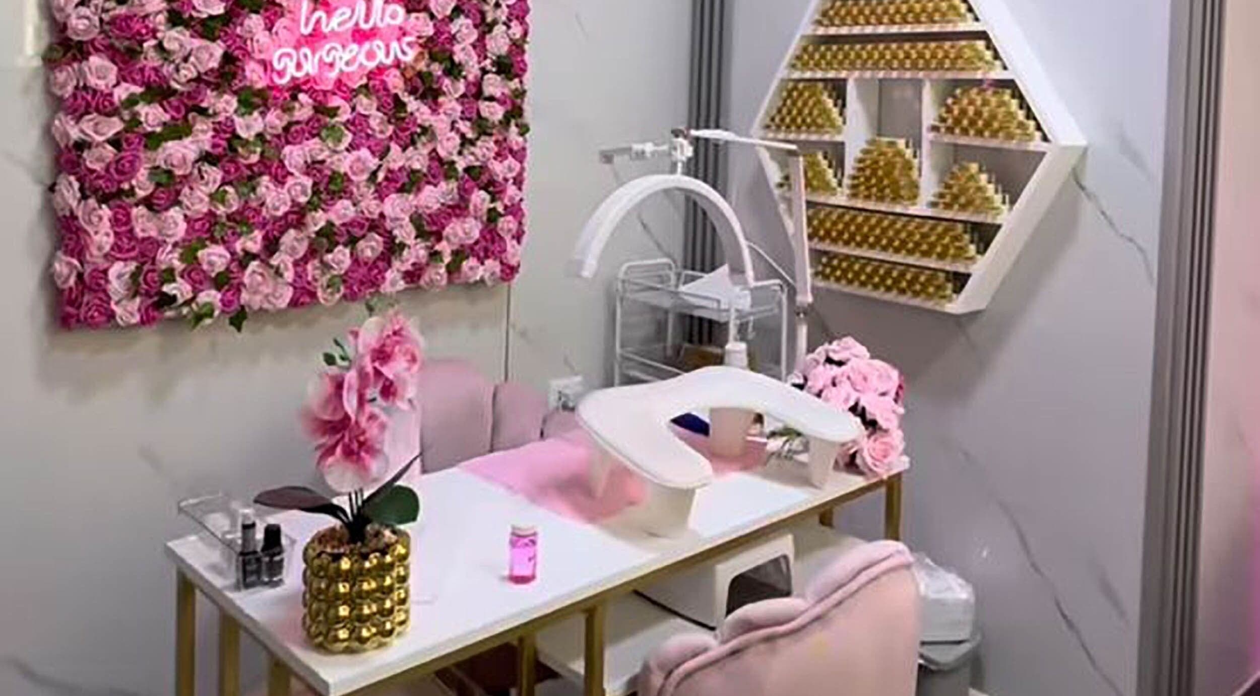 Nail station at Embelli Shed By Aya, Aley, adorned with pink roses and chic decor.