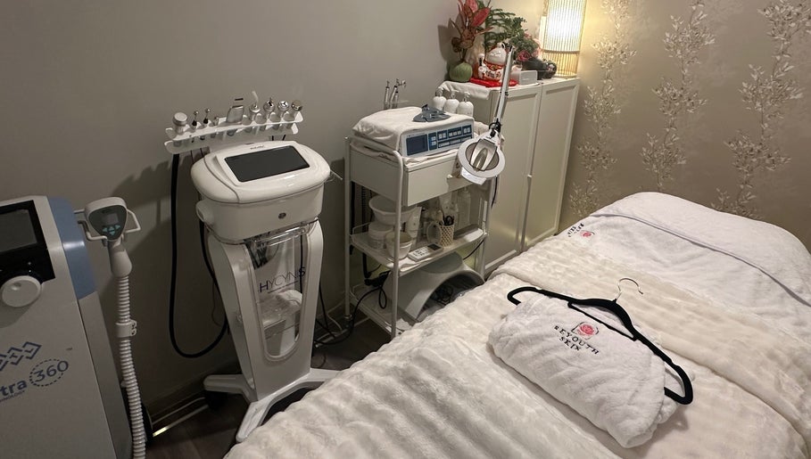 Treatment room at Reyouth Skin Beauty Care, Singapore, SG, featuring advanced skincare equipment and cozy amenities.