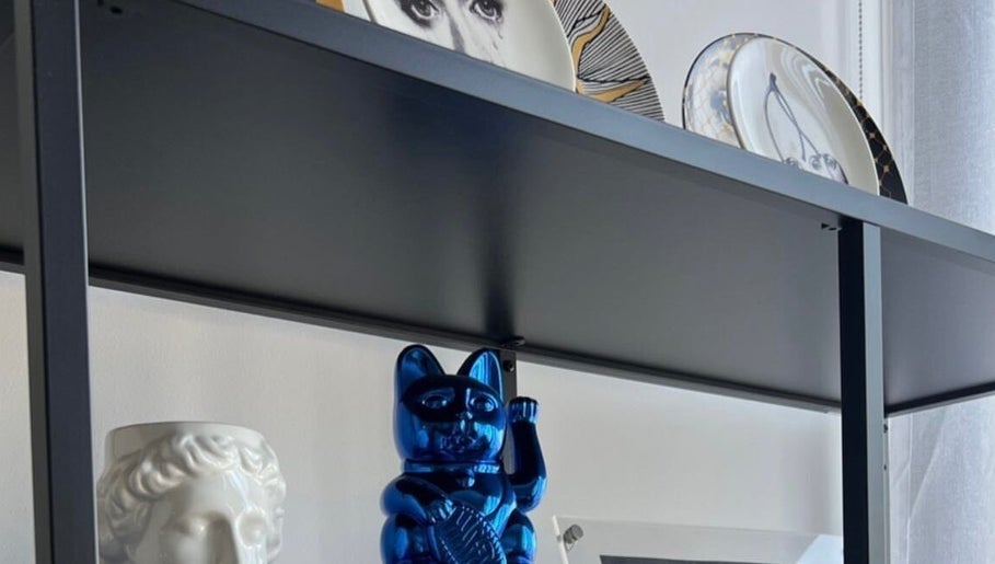 Unique decor featuring a blue cat statue and artistic plates at Uralashion in Burwood, New South Wales, AU.