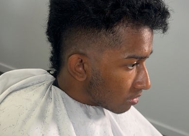 Profile of a man receiving a precision haircut at Studio M Barbers, Melbourne, Victoria, AU.