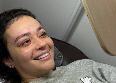 Happy client admiring brow enhancement at Duda Flores Beauty, Surfers Paradise, Queensland, AU.