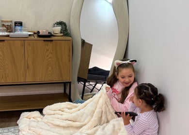 Two children enjoying a cozy corner at Duda Flores Beauty, Surfers Paradise, Queensland, AU.