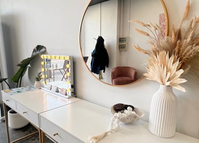 Elegant vanity at KeratinbyYing @apt.hair, Richmond, Victoria, AU, featuring chic decor and a lighted mirror.