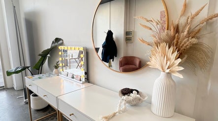 Elegant vanity at KeratinbyYing @apt.hair, Richmond, Victoria, AU, featuring chic decor and a lighted mirror.
