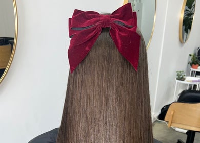 Sleek straight hair with red velvet bow at KeratinbyYing @apt.hair, Richmond, Victoria, AU.
