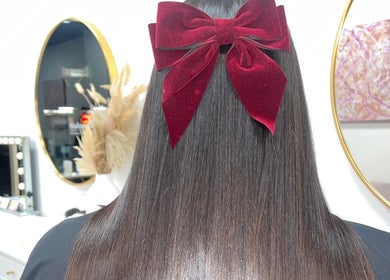 Lustrous straight hair with a red velvet bow at Keratin by Ying at Apt Hair, Richmond, Victoria, AU.