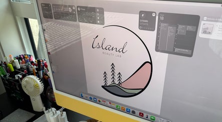 Island Beauty Labs logo on a monitor in Nanaimo, British Columbia, CA creative workspace.