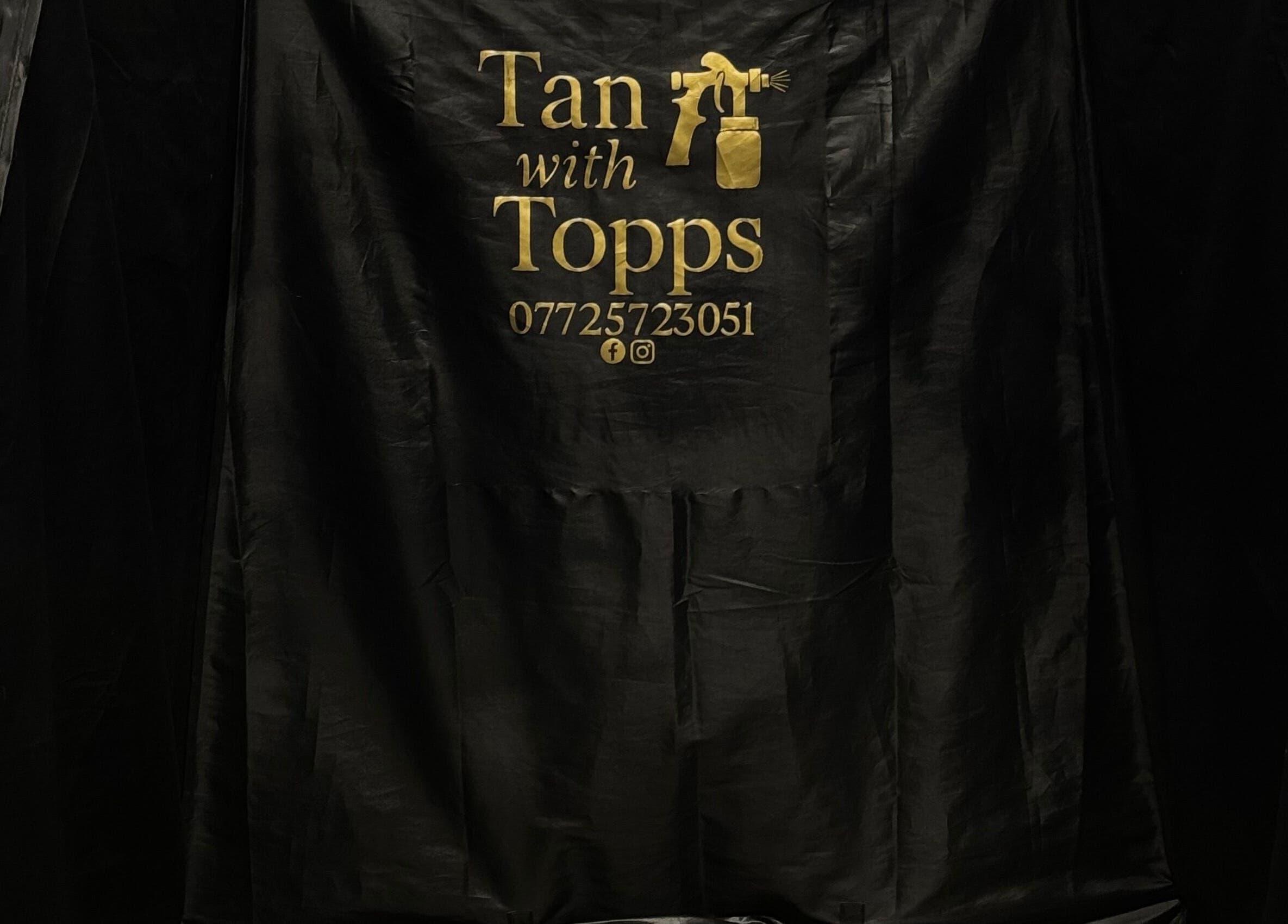 Black tanning tent with Tan with Topps logo at Torquay, England, GB for premium spray tans.