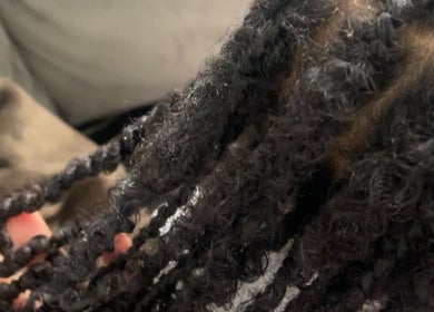 Close-up of beautifully styled curls at Cultured Curls, London, England, GB. Perfect for natural hair care.