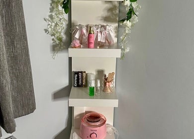 Elegant shelf with beauty products at E.loubeauty, Poole, England, GB. Decorated with flowers and beauty essentials.