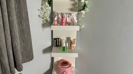 Elegant shelf with beauty products at E.loubeauty, Poole, England, GB. Decorated with flowers and beauty essentials.