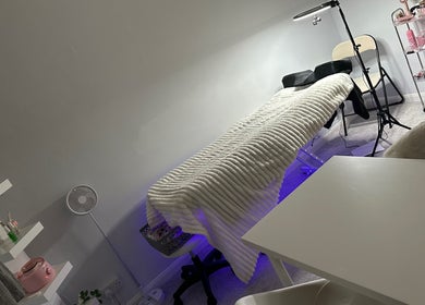 E.loubeauty therapy room features a plush treatment bed in Poole, England, GB with calming decor.