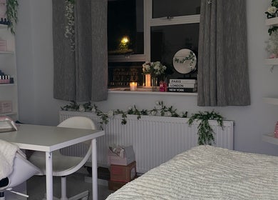 Cozy beauty treatment room at E.loubeauty, Poole, England, GB with gentle lighting and elegant decor.