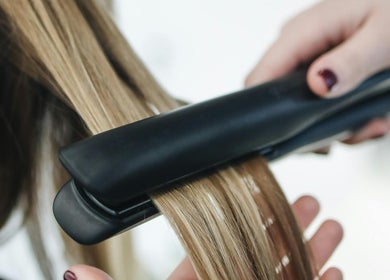 Expert hairstyling at Edmond Bunce Hairdressing in Hamilton, Scotland, GB featuring sleek straightened hair.
