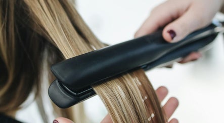 Expert hairstyling at Edmond Bunce Hairdressing in Hamilton, Scotland, GB featuring sleek straightened hair.