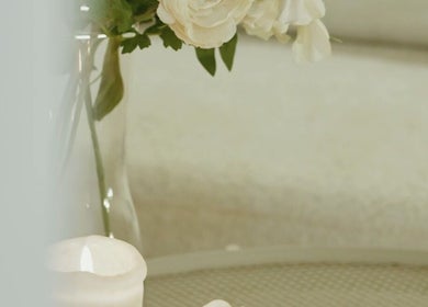 Elegant decor with a lit candle and flowers at Mahshid hair club, Muscat, Muscat Governorate, OM.