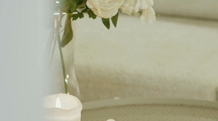 Elegant decor with a lit candle and flowers at Mahshid hair club, Muscat, Muscat Governorate, OM.
