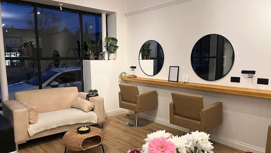 Modern lounge at Nails By Mali, Llandybie, Wales, GB with cozy seating, mirrors, and decor.