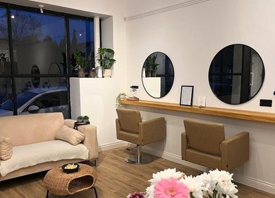 Modern lounge at Nails By Mali, Llandybie, Wales, GB with cozy seating, mirrors, and decor.