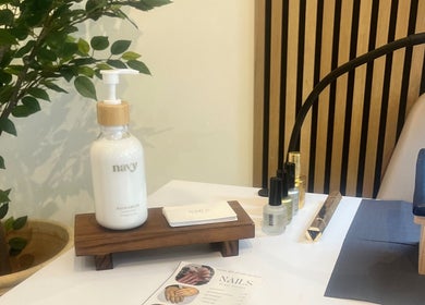 Cozy nail care setup at Nails By Mali in Llandybie, Wales, GB featuring hand cream and nail polish.