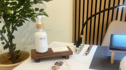 Cozy nail care setup at Nails By Mali in Llandybie, Wales, GB featuring hand cream and nail polish.
