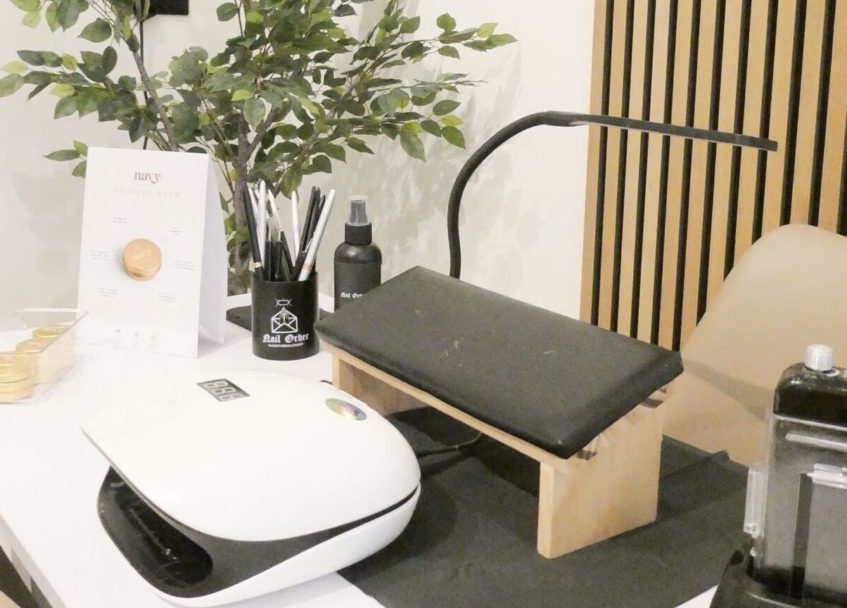 Modern nail station at Nails By Mali, Llandybie, Wales, GB, featuring tools and greenery.