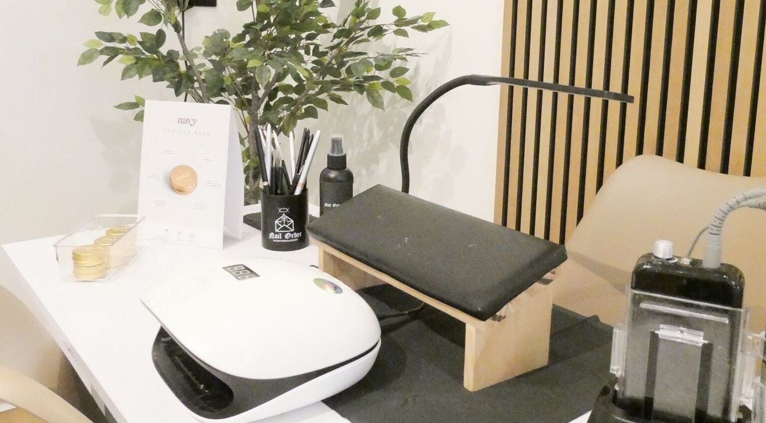 Modern nail station at Nails By Mali, Llandybie, Wales, GB, featuring tools and greenery.