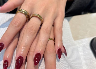 Elegant maroon nails with gold rings at Beauty Point GC, Robina, Queensland, AU.