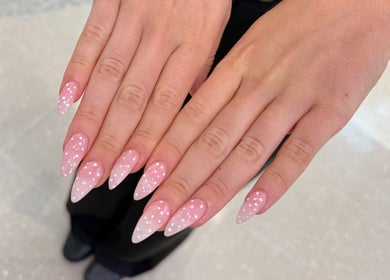 Stylish pink polka dot nails at Beauty Point GC, Robina, Queensland, AU, showcasing intricate nail art design.