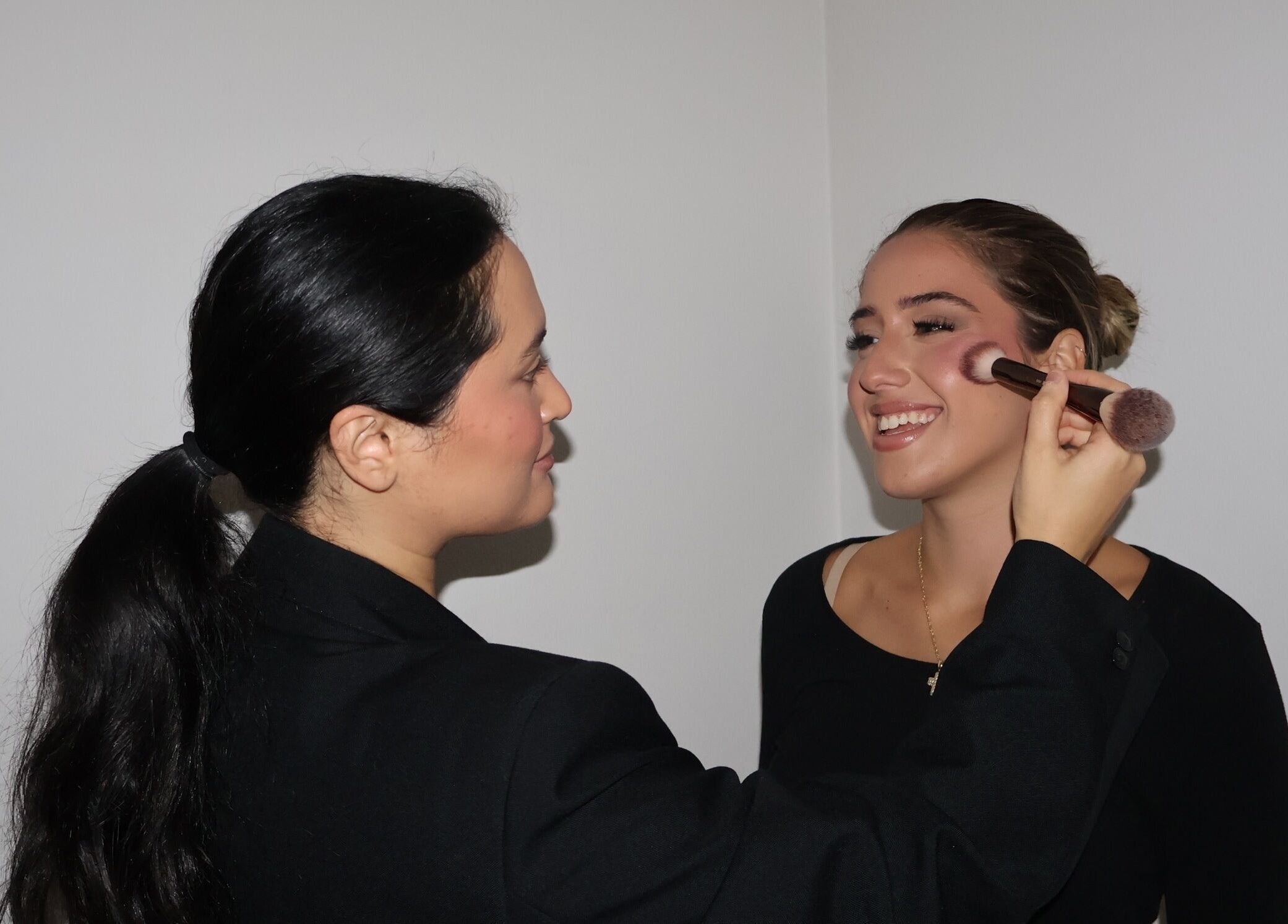Makeup artist applying blush at Makeup By Georges in Pymble, New South Wales, AU.