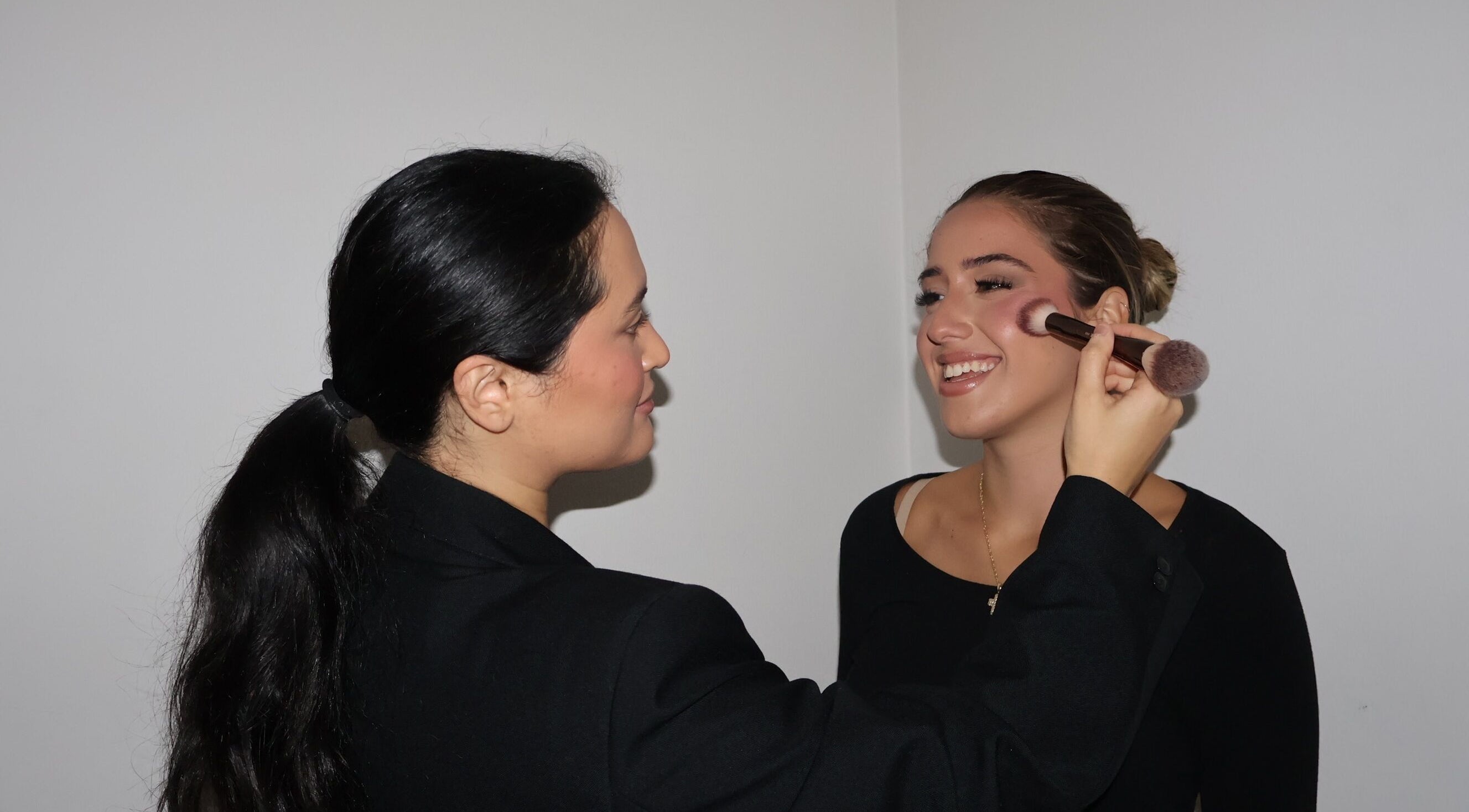 Makeup artist applying blush at Makeup By Georges in Pymble, New South Wales, AU.