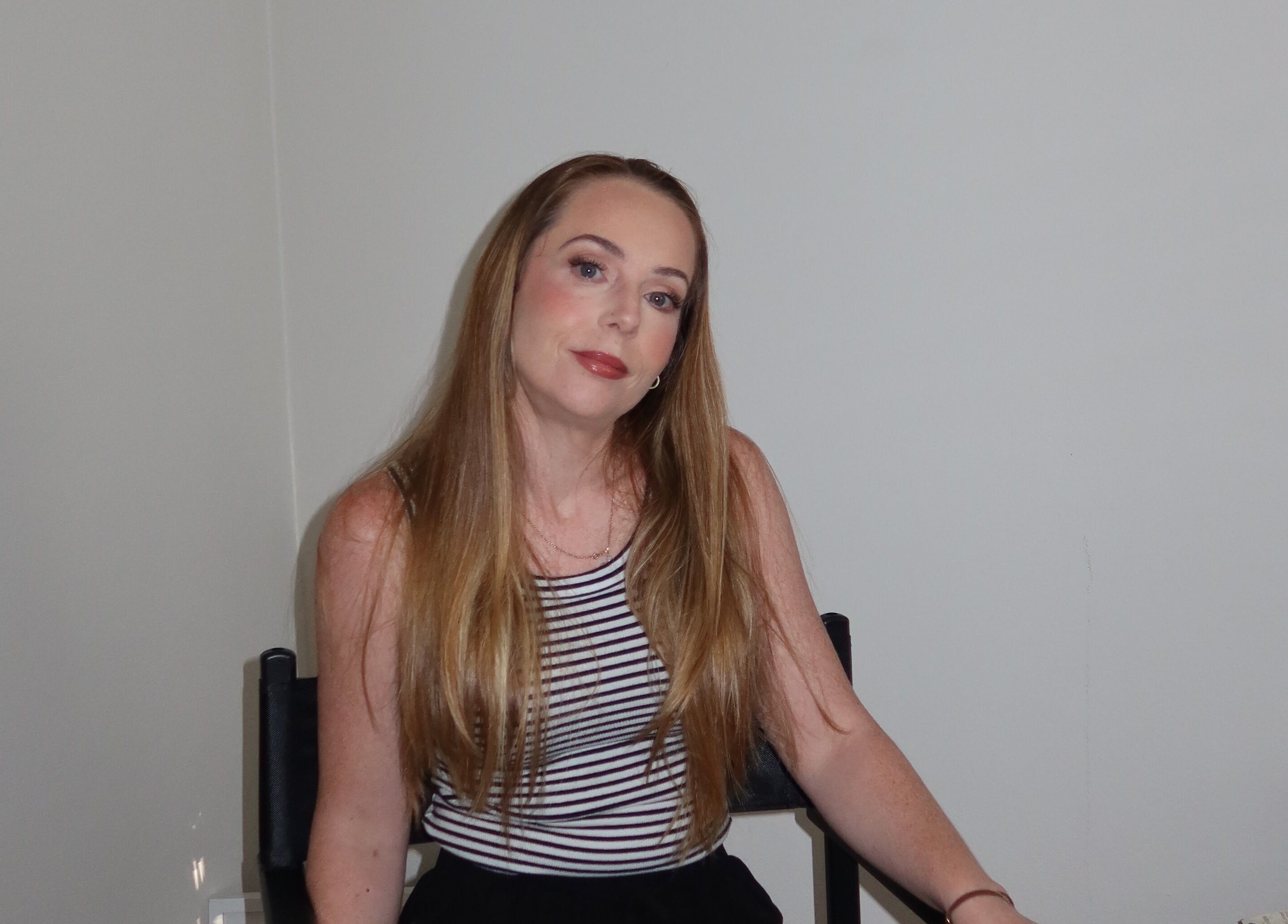 Woman with long hair at Makeup By Georges, Pymble, New South Wales, AU., poised for a beauty session.
