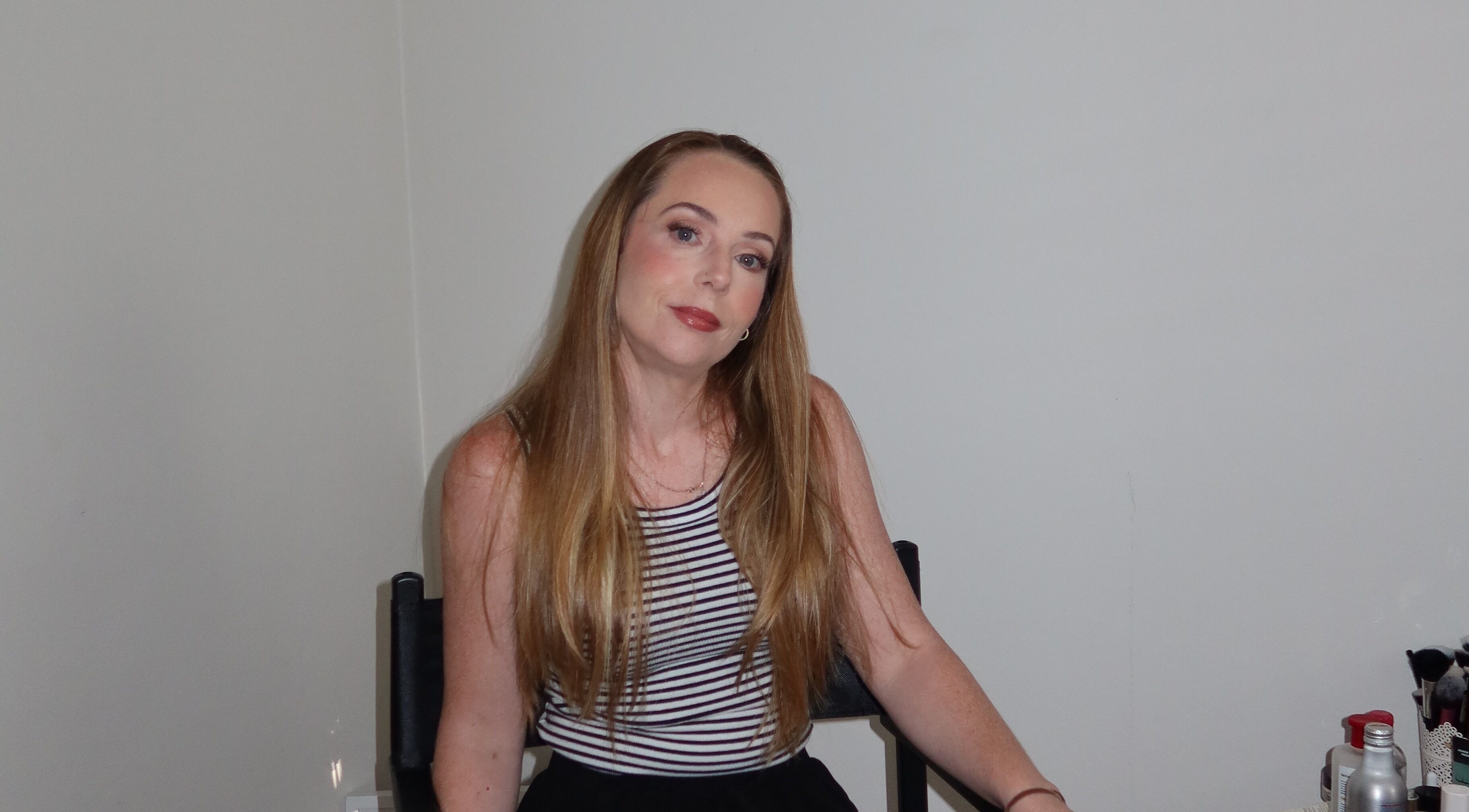 Woman with long hair at Makeup By Georges, Pymble, New South Wales, AU., poised for a beauty session.