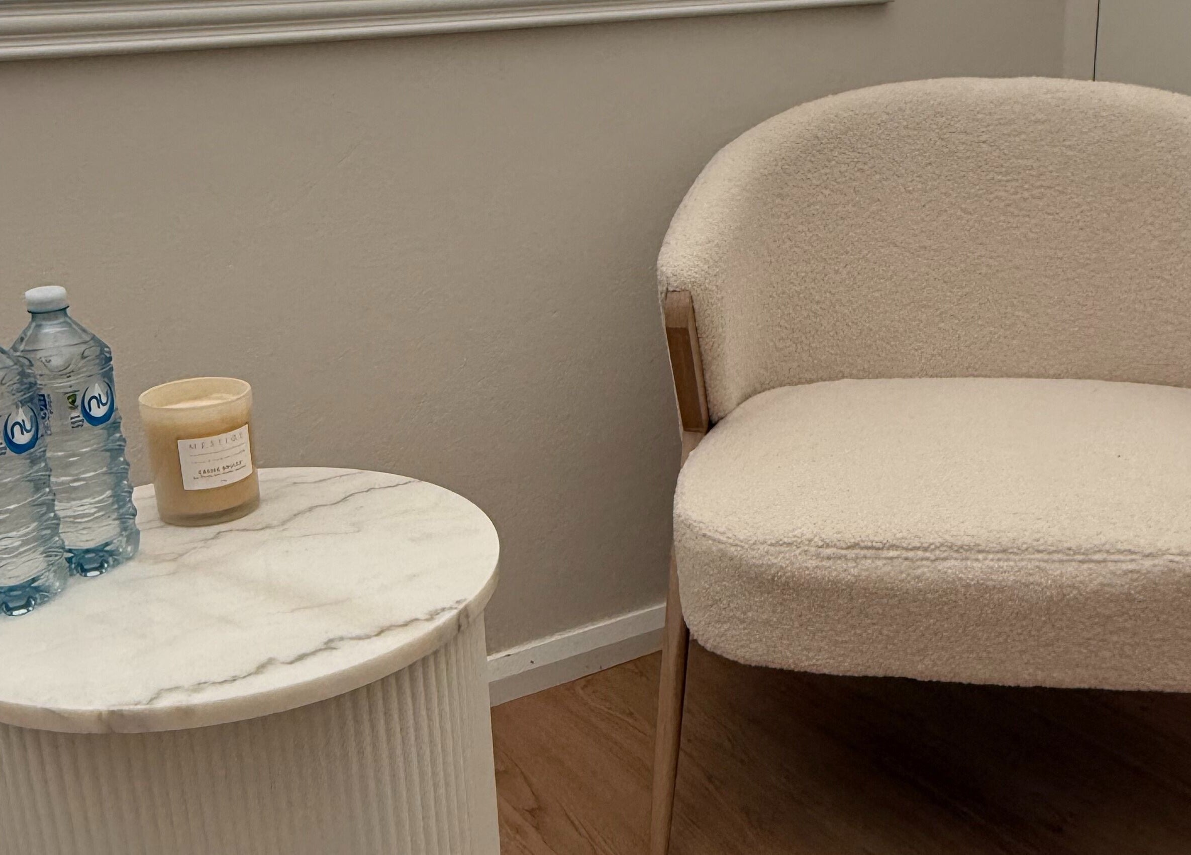 Cozy waiting area at Makeup By Georges, Pymble, New South Wales, AU with a chair and marble table.