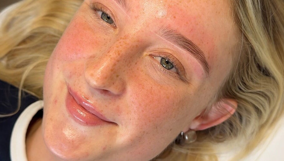 Close-up of a smiling woman showcasing perfect brows at Everythingbrows, Hull, England, GB.