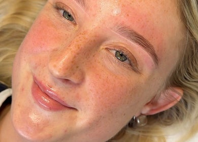 Close-up of a smiling woman showcasing perfect brows at Everythingbrows, Hull, England, GB.